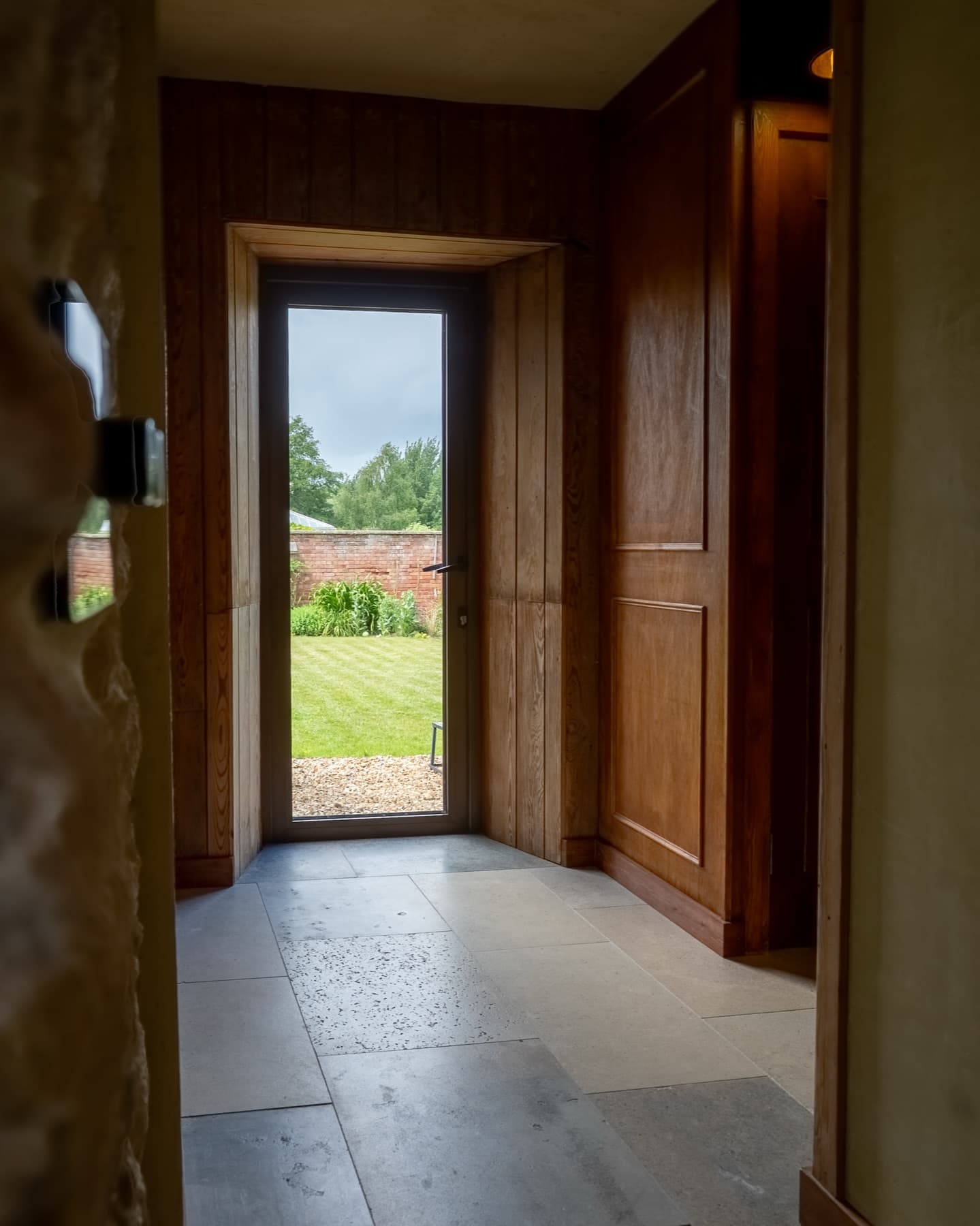 Oak door and deep stone reveal opening to the garden
